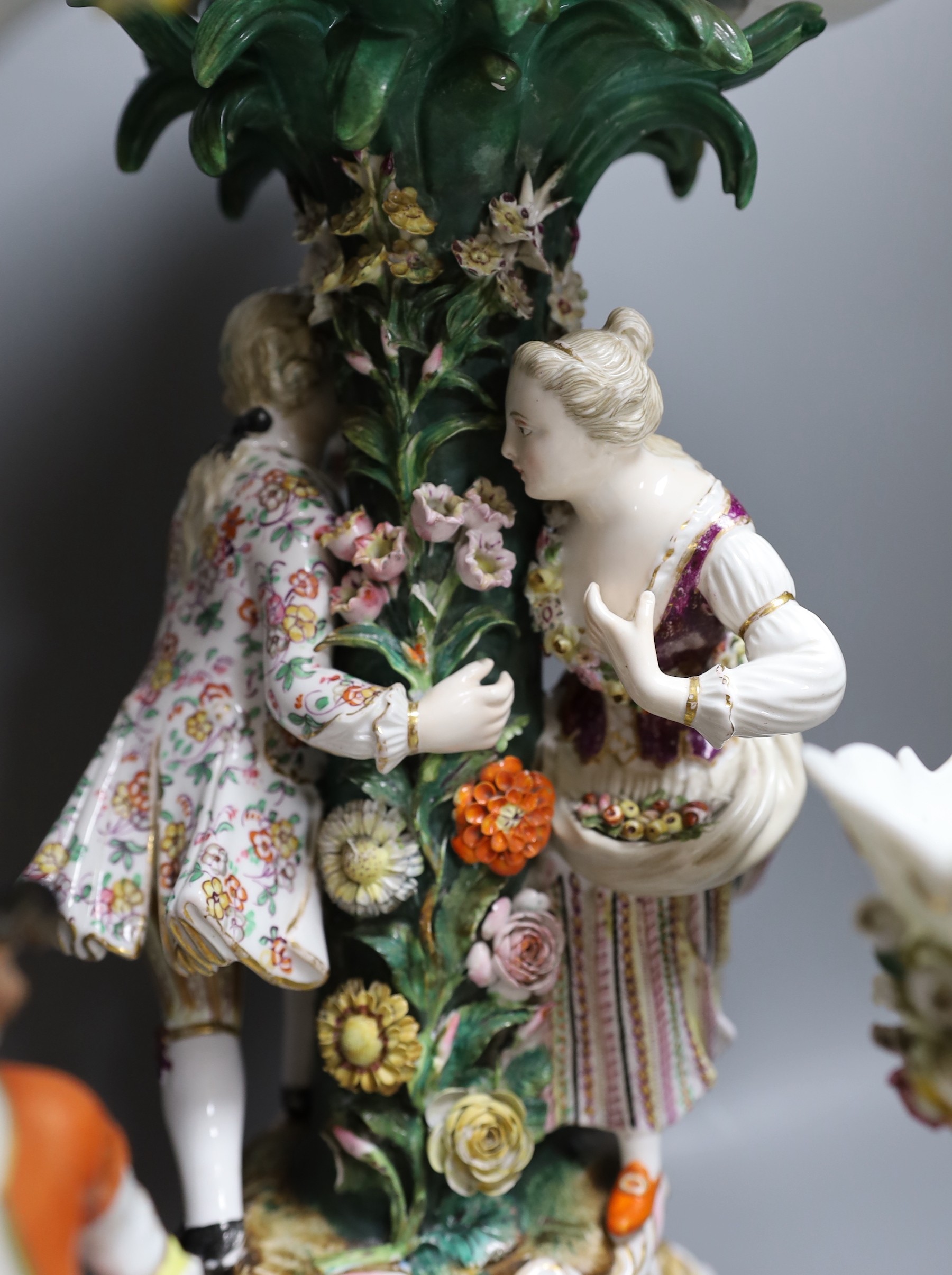 A 19th century Dresden floral encrusted centrepiece and two other continental porcelain centrepieces, tallest 46cm